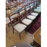 A set of four Edwardian inlaid mahogany salon chairs with scroll top rails, padded back and