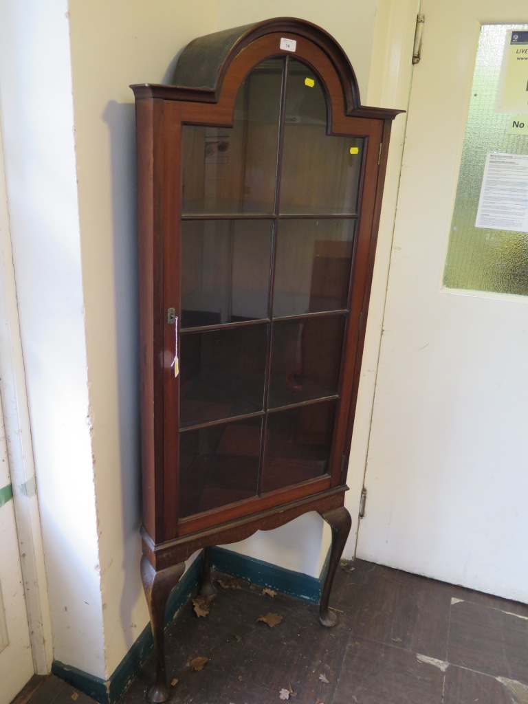 A 1920's mahogany corner cabinet, with arched glazed door in cabriole legs and club feet, 65cm wide,