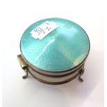 A silver trinket box on three legs having an enamel lid, as found