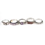 A collection of five silver and gem set rings