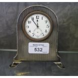 A silver mounted bedside clock, as found