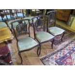 A set of three inlaid mahogany salon chairs, the pierced inlaid shell shape backs above