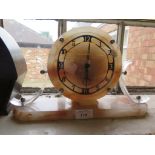 A 1930's pink alabaster mantel clock with clear plastic supports and Temco movement, 19.5cm