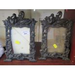 A pair of bronzed metal photo frames, early 20th Century, cast with swans, water lillies and