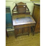 An Edwardian inlaid rosewood Davenport, the raised mirrored back with tambour front and drawers,