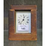 An Edwardian brass carriage timepiece with enamel dial within a leather case. 14cms high