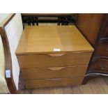 A small three drawer teak bedside chest of drawers (Europa furniture label inside)