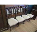 A set of four Edwardian stained beech salon chairs, with interlaced vase shape splats above stuff