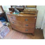 An early 19th century mahogany bowfront chest of drawers with three long drawers on outsplayed