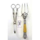 A pair of silver plated grape scissors and a bread fork