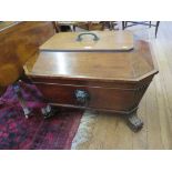A Regency mahogany cellarette, of sarcophagus form, with rope twist handle to the lid and lion