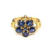 A blue sapphire and diamond cluster ring set in 9 carat gold
