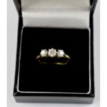 A fine quality three stone diamond ring set in 18 carat gold and platinum. Total diamond weight