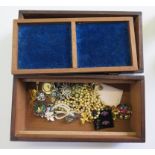 A wooden box with a small collection of costume jewellery