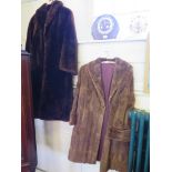 A three quater length fur coat, and another coat similar