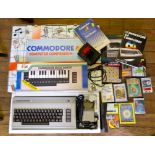 A Commodore 64 computer compendium with music maker, cassette deck, games, joystick and manual
