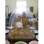 A Victorian gilt metal mantel clock, depicting a figure and artists materials next to the drum