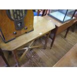 An oak octagonal occasional table on turned legs and cross stretchers, 91cm wide and a teak sewing