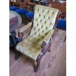 A Victorian mahogany armchair, the scroll button back and seat on outsplayed legs with hoof feet