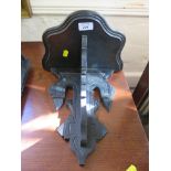 A 19th century ebonised wall bracket, with shaped shelf and pendant supports, possibly German,
