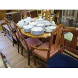 A Nathan crossbanded teak extending dining table and six chairs, including two carvers, table