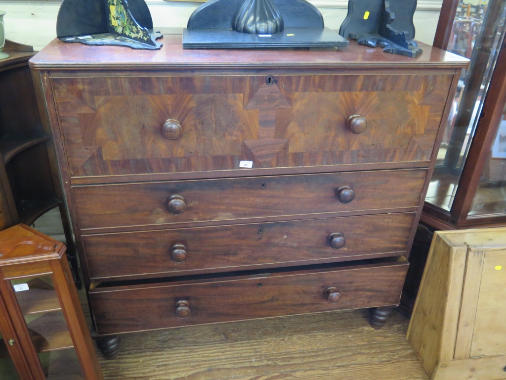 An early 19th Century mahogany chest of drawers, the hinged top with dummy secretaire front over