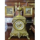 A late 19th century French brass mantel clock, with repeat mechanism, the square case surmounted