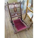 An Edwardian inlaid mahogany folding chair, the rail back depicting an urn of flowers, over a padded