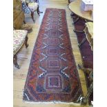 A Turkoman runner, with a single row of geometric medallions in a serrated border, 362cm x 80cm