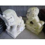 A pair of hardstone Imperial lion figures, each with a ball held under a front paw, 16cm high