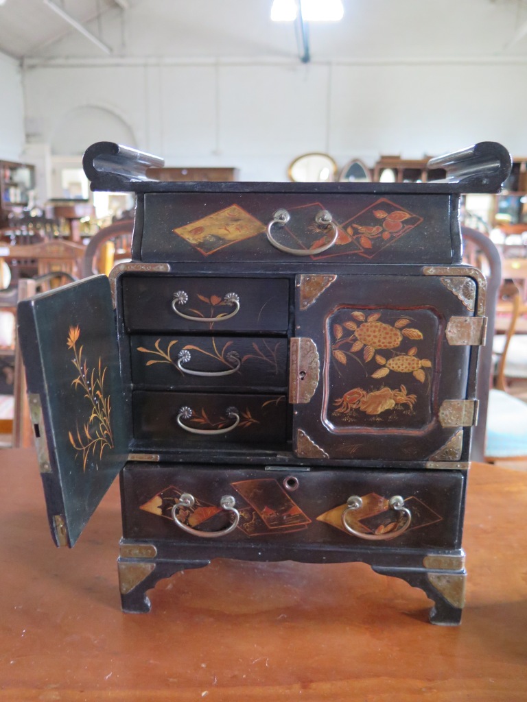 A Japanese lacquer table cabinet, with frieze drawer over cupboard doors and long drawer on