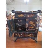 A Japanese lacquer table cabinet, with frieze drawer over cupboard doors and long drawer on
