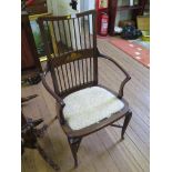 An Edwardian inlaid mahogany open arm chair, with spindle back, scroll inlaid rail and cabriole legs