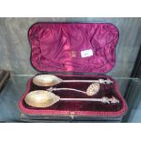 A Victorian silver fruit set consisting of two large serving spoons with gilt bowl and grape and