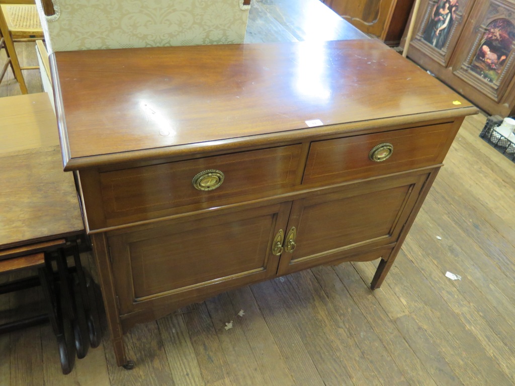 An Edwardian mahogany and chevron banded dressing table, with two frieze drawers over cupboard doors