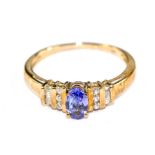 A tanzanite and diamond ring set in 9 carat gold