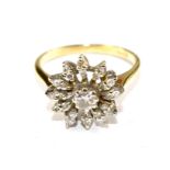 A diamond set flower head ring in 18 carat gold