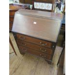 An Edwardian mahogany and satinwood crossbanded bureau, with sloping fall front above three long