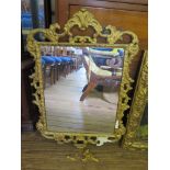 A George III style gilt gesso wall mirror, the rectangular plate with an open scroll frame, 80cm x
