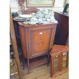 An Edwardian mahogany and satinwood crossbanded side cabinet, with raised back and shaped sides, the