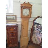 An early 19th century pine longcase clock, with swanneck pediment, the painted dial with floral