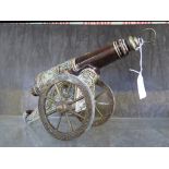 A German stoneware decanter in the form of a cannon, on a brass carriage, shield mark to base,