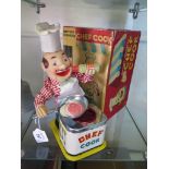 A Japanese tin plate battery operated 'Chef Cook' by Yonezawa Toys, with two fried eggs and original