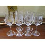 A set of six tulip shape wine glasses depicting grapes and vines