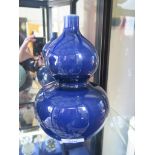 A Chinese blue glaze double gourd vase with six character mark for Kangxi, 23cm high