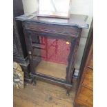 An Edwardian stained wood display cabinet, the shaped top over a shaped glazed door on cabriole
