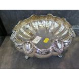 A silver bowl of scalloped form on four feet with swag decoration, by Elkington & Co, Birmingham