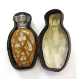 A faceted orange glass scent bottle with intaglio flower decoration. The silver top enclosing the