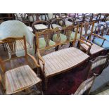 An Edwardian inlaid mahogany and rosewood salon suite, comprising two seat settee and two armchairs,