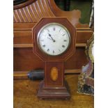 An Edwardian mahogany and boxwood mantel timepiece, of octagonal form with patera inlay to the stem,